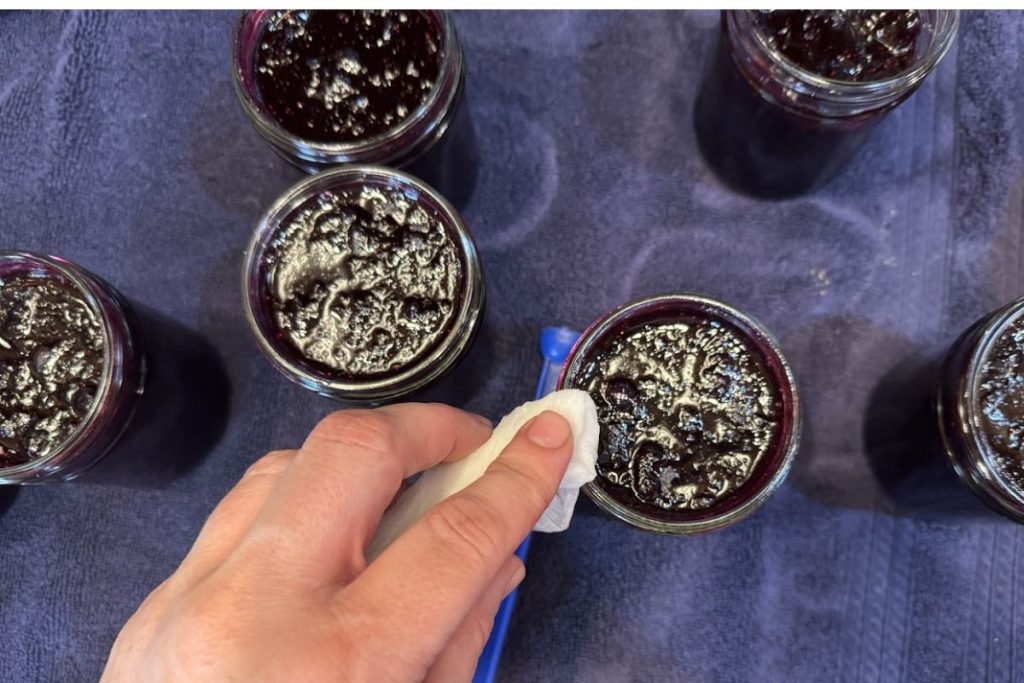 Wipe the rims of the filled jars before adding canning lids.